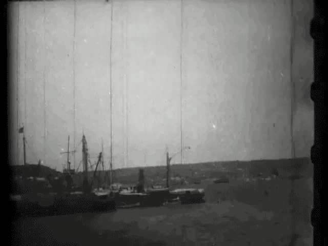 Old black and white video clip taken in Havana Harbor from a moving launch, and shows the wreck of the "Maine" surrounded by wrecking boats and other vessels.