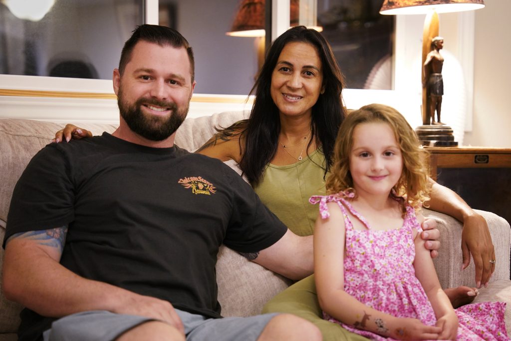 Mike, Andreza and Ellie Cicchino are photographed at his mother’s house Thursday, Nov. 16, 2023, in Waihee-Waiehu. The Cicchinos lost their family home in the Aug. 8 Lahaina fire. (Kevin Fujii/Civil Beat/2023)