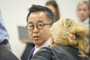 Glenn Wakai chats with Lynne DeCoite, before a committee hear for the financing of Bills 
(David Croxford/Civil Beat/2024)