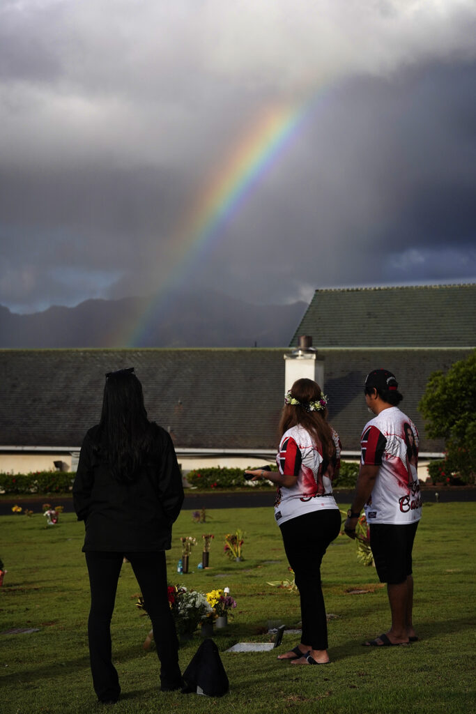 A rainbow forms while visiting Theresa Cachuela’s grave Sunday, Dec. 15, 2024, at the Mililani Memorial Park and Mortuary in Mililani. Theresa was killed almost one year ago by her estranged husband Jason Cachuela despite a temporary restraining order. (Kevin Fujii/Civil Beat/2024)