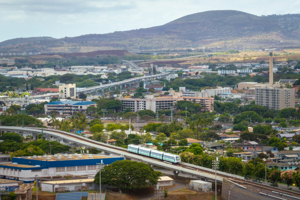 An aerial view of the Skyline traveling west through Waipahu towards Kapolei.